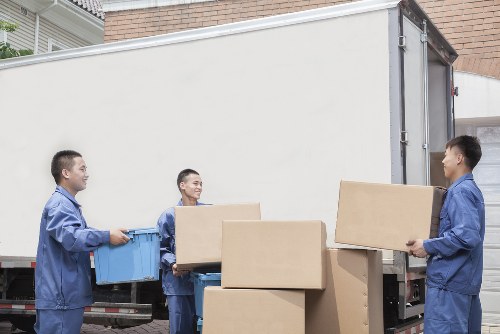 Furniture and boxes being transported by a local removals van