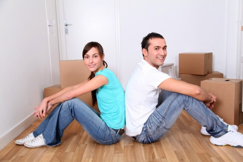 Professional movers loading household items in a North London street