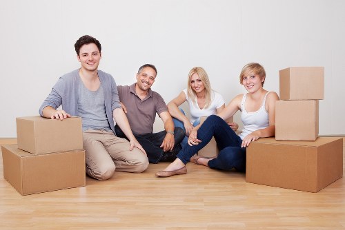 Packed boxes and furniture ready for loading by local movers